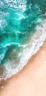 Aerial view of a turquoise ocean meeting a sandy beach with gentle waves.