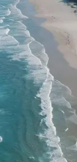 Aerial view of beach and ocean waves hitting the shore for mobile wallpaper.