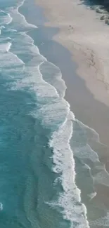 Aerial view of a beach with teal ocean waves and sandy shores.