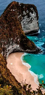 A stunning beach cliff with ocean and white sandy beach.