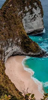 A breathtaking view of a beach with a towering cliff and turquoise waters.