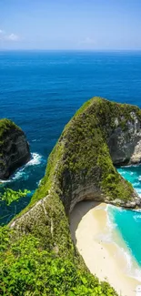 Beautiful beach with turquoise waters and lush green cliffs under a clear blue sky.