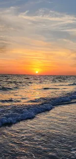 Glorious sunset over a calm ocean with vivid, warm colors on the horizon.