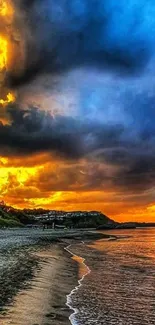 Vibrant sunset over beach with orange clouds and blue sky.