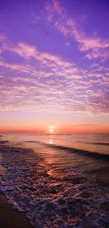 Beautiful beach sunset with a purple sky and gentle ocean waves.