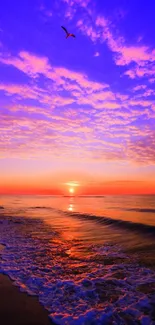 Vibrant sunset over ocean waves with purple and orange hues.