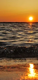 Golden sunset over beach with ocean waves and bright horizon.