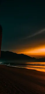 Stunning sunset over a tranquil beach with vivid orange and dark tones.