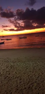 Stunning sunset over a serene beach with boats and vibrant sky.