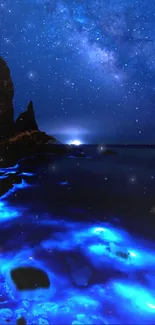 Bioluminescent ocean under a starry night sky.