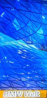 Futuristic blue glass architecture of BMW Welt at night.