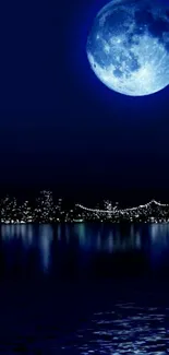 Blue moon over city skyline with water reflection.