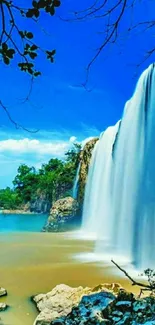 Stunning blue waterfall under a bright sky with lush surroundings.