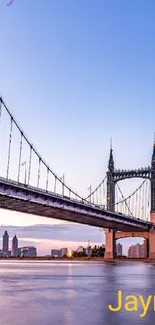 Elegant sunset bridge reflecting on water in a serene cityscape.