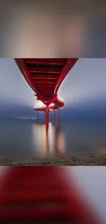 Illuminated bridge over calm night waters in striking wallpaper.