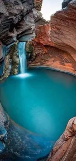 Canyon waterfall with blue pool and red rock formations, creating a serene scene.