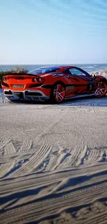 A vibrant red sports car on a sandy beach under a clear blue sky.