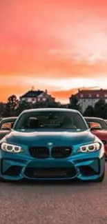 Cars lined up under a vibrant orange sunset sky.