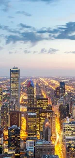 Beautiful dusk view of the Chicago skyline with city lights and a blue sky.