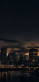 City skyline at night with lights reflecting on water.