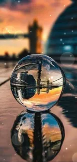 Crystal ball reflecting cityscape at sunset with blurred background.