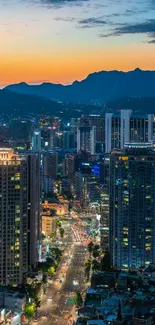 Vibrant cityscape at dusk with illuminated buildings and a stunning evening sky.