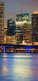 Vibrant city skyline at night with blue reflections.