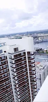 Tall skyscraper cityscape view with river backdrop.