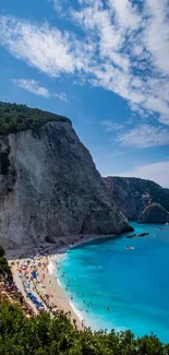 Breathtaking view of a cliffside beach with azure waters and clear blue skies.