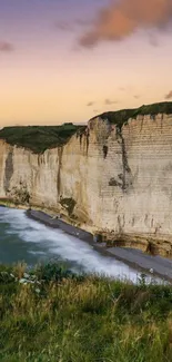 Majestic cliffs meeting the ocean during sunset, offering a serene natural view.