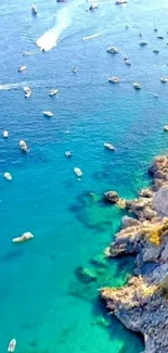 Aerial view of turquoise coastline with boats and rocky cliffs.