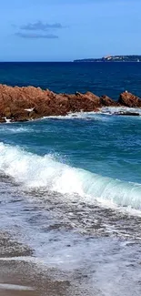 Coastal beach view with azure waves crashing on the sandy shore.