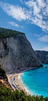 Breathtaking coastal beach with azure waters and a towering cliff under blue skies.