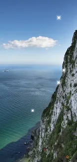 A stunning view of a coastal cliffside with a bright blue sea and clear skies.