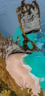 Turquoise waters and sandy beach with towering cliffs.