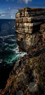 Majestic coastal cliff with ocean view and deep blue sky.