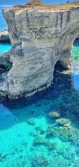 Cliff over crystal turquoise waters, serene coastal view.