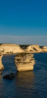 Majestic coastal cliffs against clear blue sky.