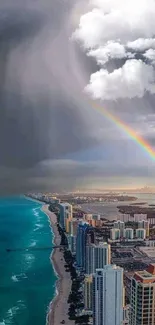 Coastal cityscape with vibrant rainbow and storm clouds over the ocean.