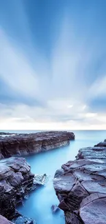 Blue sky and rocky coastline mobile wallpaper.