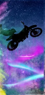 Silhouetted biker jumping over a cosmic galaxy with vibrant colors and light trails.