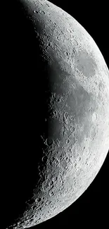 Crescent moon with detailed craters against a dark sky.