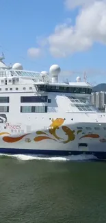 Elegant cruise ship on the ocean with city skyline in the background.