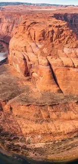 Majestic desert canyon with winding river and clear sky.