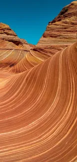 Majestic desert rock waves against a clear blue sky.