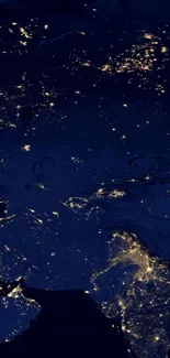 A stunning view of Earth at night from space with glowing city lights across continents.