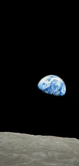 Earthrise over lunar surface in space