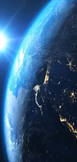 Mobile wallpaper of Earth from space with glowing cities.