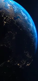 A stunning view of Earth from space showing city lights against the dark cosmos.