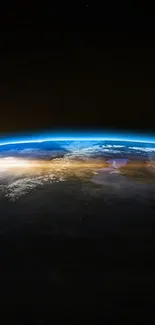 View of Earth from space with a sunrise on the horizon and moon visible in the backdrop.